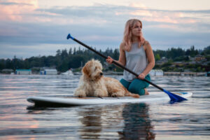 woman and dog on paddle board