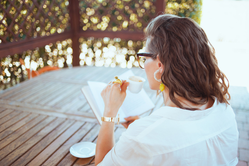 Woman on porch reading a book