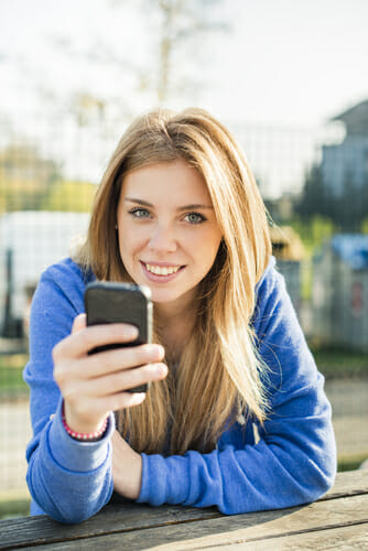 Woman checking her LASIK candidacy on a smartphone